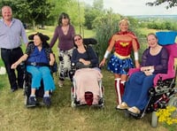Wonder Woman accepts cheque from care home