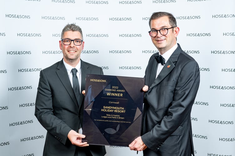 Scott Hibbard, General Manager at Sandymouth Holiday Resort receives the award from Paul Evans, Vice President - Portfolio, at Awaze â the parent company of Hoseasons (right)