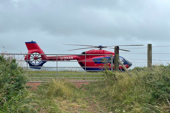 The Devon Air Ambulance in a field close to the scene.  AQ 2002