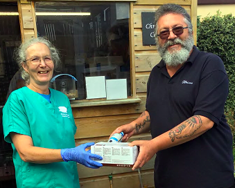 Diane South of ‘Prickles and Paws’ receives donated supplies from Peter English of the Oddfellows; left, one of the charity’s rescued hedgehogs