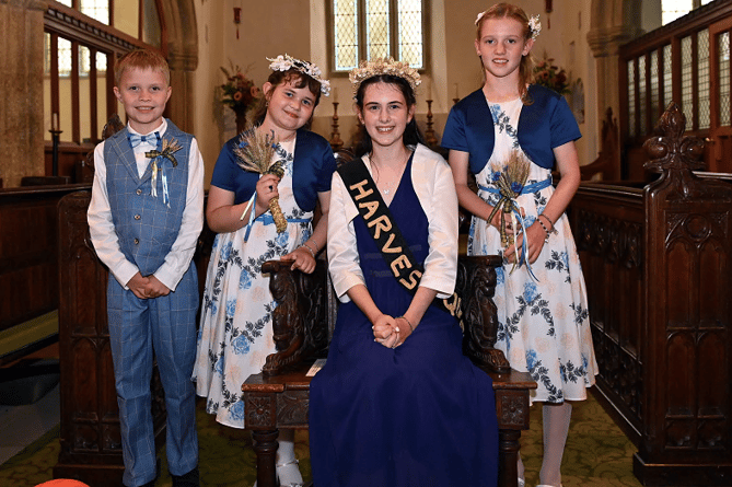 The newly elected harvest queen proudly shows off her crown along with her attendants pictured are George Horrell (page boy), Annabelle Shipton-Goode (attendant), Pamela Morrison (harvest queen) and Maeva Motsch (attendant). Pictures: Adrian Jasper