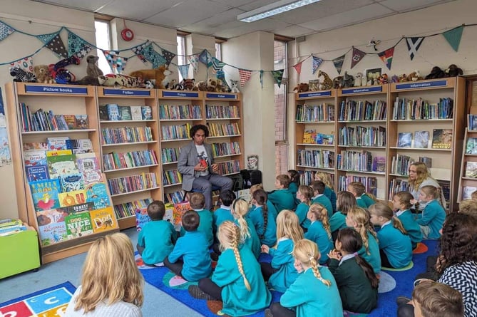 Joseph reading to local children during his visit to Launceston Library