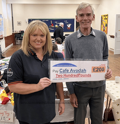 Paul Jellyman from Launceston Community Market presenting a cheque for £200 to Teresa Pickup from Avodah Cafe