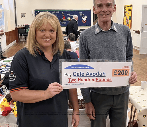 Paul Jellyman from Launceston Community Market presenting a cheque for £200 to Teresa Pickup from Avodah Cafe