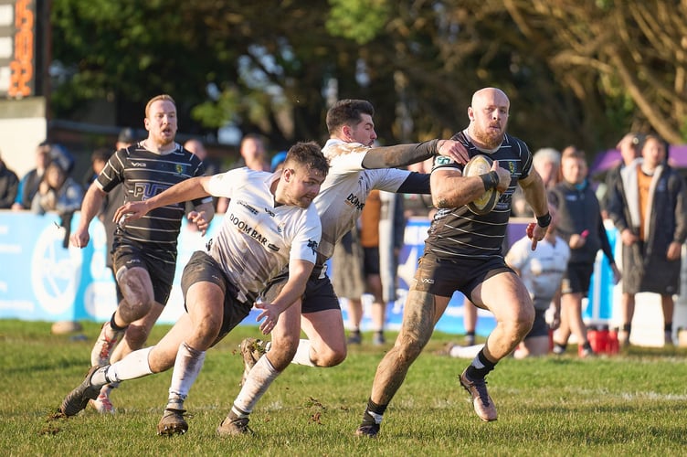 Launceston duo Tom Sandercock (left) and James Tucker try to tackle Brixham winger Matt Crosscombe.