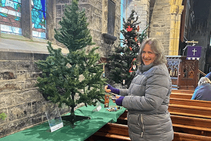 Mrs Elizabeth Brown, one of the organisers of the event, putting together the WI tree