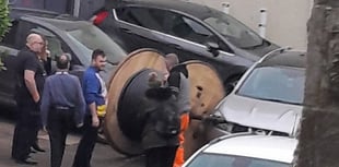 Cars damaged after large wire reel escapes trailer in Bodmin