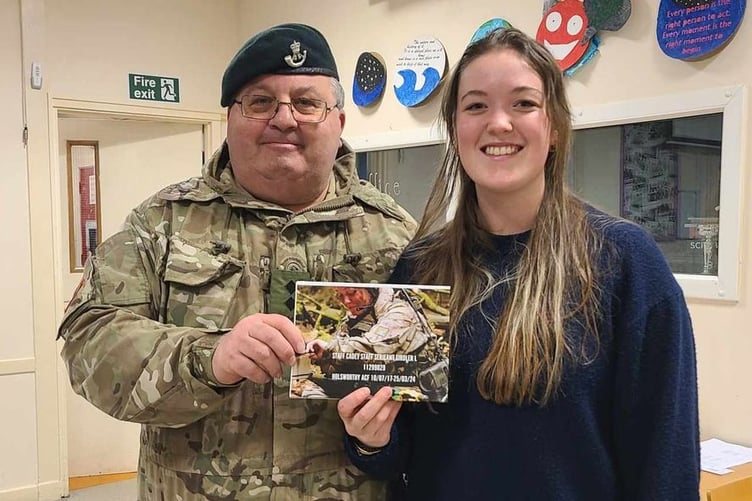 Lydia Girdler receiving her memory book from Lt Jim Harvey