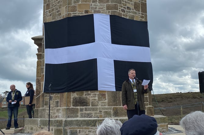 Cllr Mike Dawe stood next to the iconic Cornish flag 