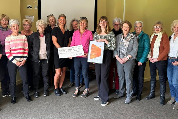 Passing a £1,800 cheque to the Multiple Sclerosis Society