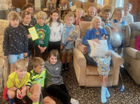 School children help resident celebrate 100th birthday