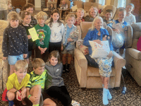 School children help resident celebrate 100th birthday