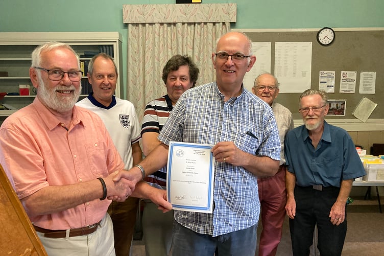 Neil Sargent Chairman of the Cornwall Philatelic Federation presenting club member Barry Mudie with his Certificate for being awarded a Large Gold Medal in the National Inter-Federation Competition at York