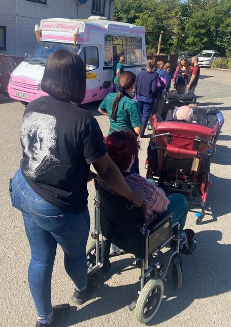 Residents of Kernow House being taken to receive their prize