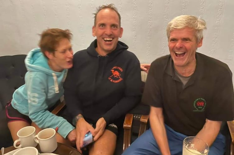 Matt, Sam, and Jon celebrating in Camelford Conservative Club after their day 1000th run