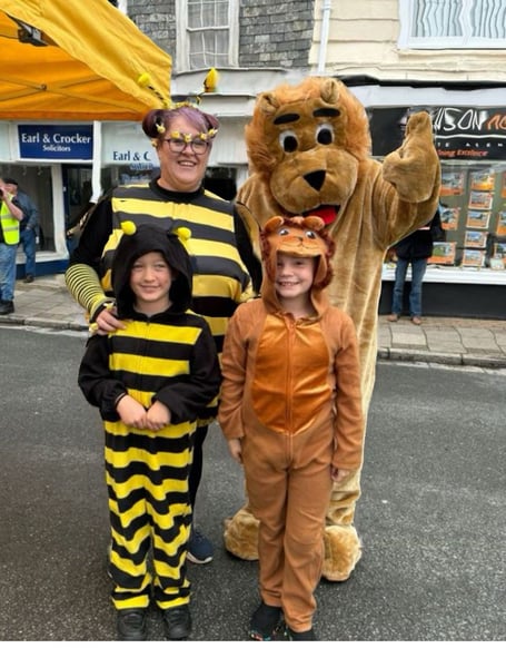 Callington Honey Fair mascots Lenny the Lion (Archie Worth), Bizzy the Bee (Jo Worth) and Mini Mascots (Fletcher Worth and Mika Pedrick)