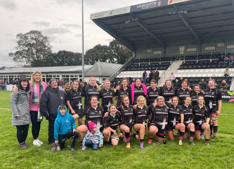Launceston's players and supporters celebrate on the pitch at Polson Bridge after their nailbiting success over Crediton. Picture: Dan Pearce