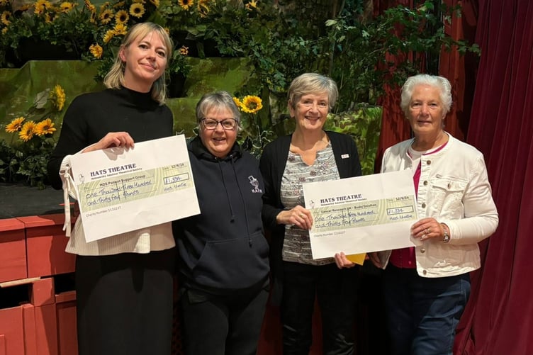 Representatives from two charities are given cheques for £1,334 each after HATS sell-out run of Calendar Girls