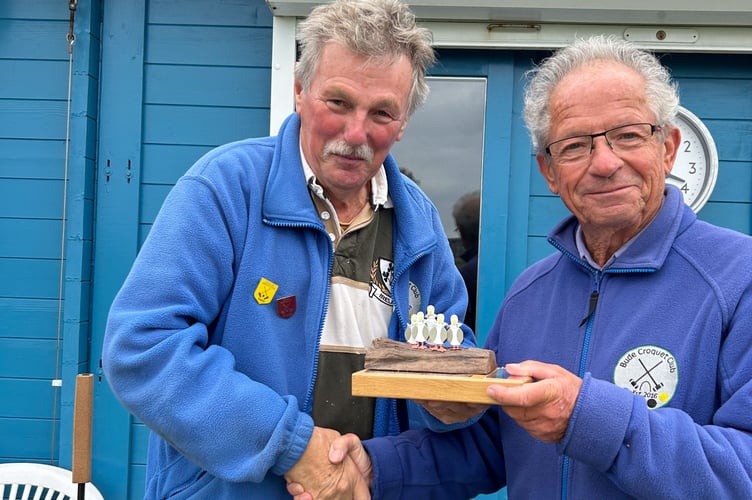 Chairman Chris Ham presents Tim Benson with the trophy. Picture: Bude Croquet Club