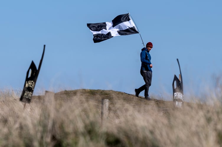 The St Piran flag flying in the breeze at the 2025 St Piran Play, Perranporth