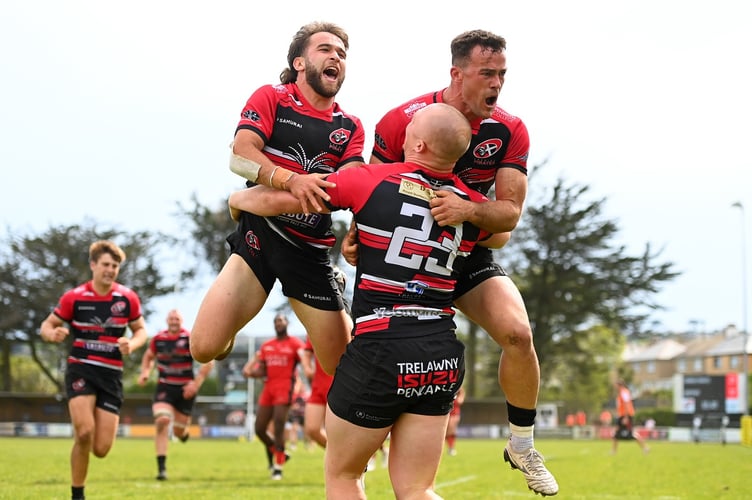 Dan Hiscocks and Will Trewin celebrate with try-scorer Will Yates as the Cornish Pirates defeated Hartpury at the Mennaye Field