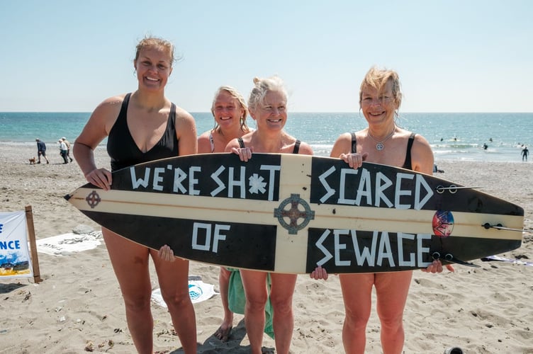 Protestors at Seaton Beach spell out their message as part of the many paddle-outs organised across the UK by Surfers Against Sewage.