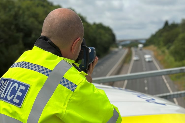 A policeman checks the speed of motorists in Cornwall