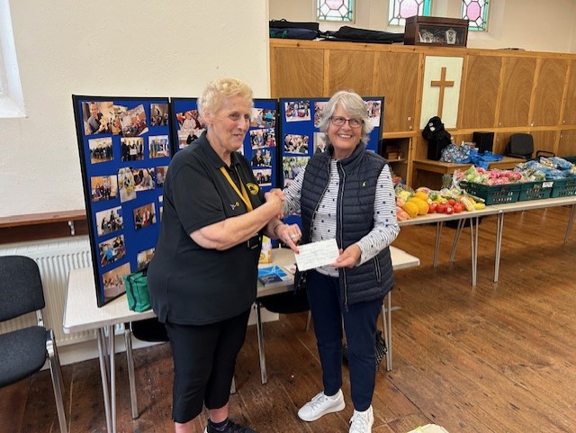 Cym Downing receiving a cheque from Launceston Inner Wheel on behalf of Launceston Memory Cafe