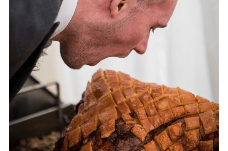 Groom sizes up the hog roast at his wedding feast  (Picture: North Devon Hog Roast)