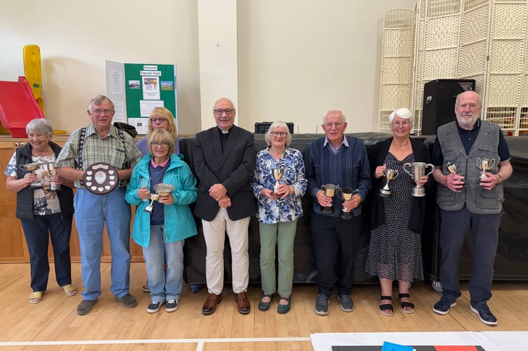 The cup winners of Halwill Flower & Produce Show, left to right, Doreen Bray, Peter Williams, Anji Hall (with Eleanor Williams stood in front of her,) Rev. Dr Paul Fitzpatrick, Pat Smallacombe, Brian Wonnacott, Betty Darke and Chris Towell