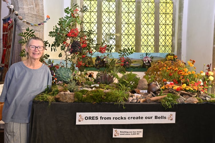 Cathy Glaser of the St Breward Hand Bell Ringers proudly stands alongside her display entitled "Ores from rocks create our bells" (Picture: Adrian Jasper) 