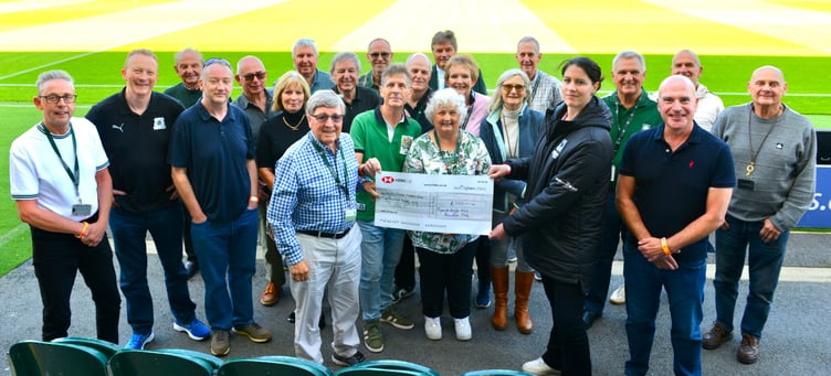 Club chairman of the Plymouth Argyle Vice Presidents Club, John McNulty, hands over a cheque to Argyle Women's head coach Marie Hourihane at Home Park