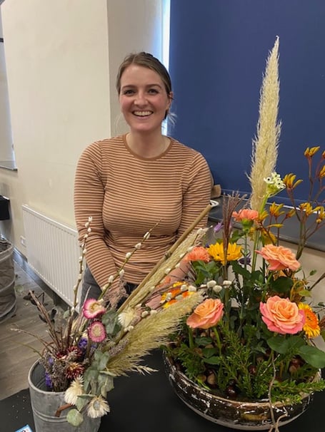 Rosy Elesmore of ‘Odds & Buds’ in Tavistock with two of the arrangements she made at Bude Flower Club's recent meeting