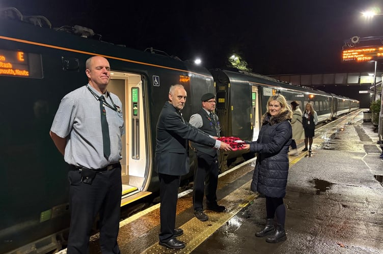 Sharon Savigar presenting a Trust wreath to Great Western Railway Poppies to Paddington staff at Liskeard train station