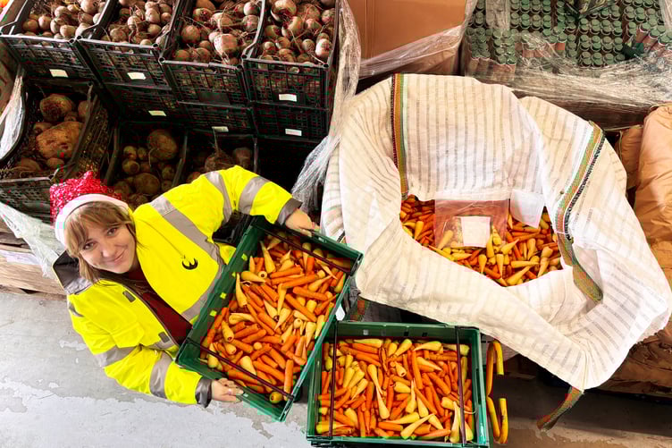 A FareShare SW volunteer with carrots.