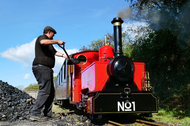 A railway operations assistant at Lappa Valley fills the coal bunker on the railway’s flagship engine Zebedee