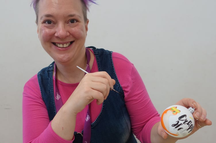 A big smile from Alison as she decorates some festive ball balls