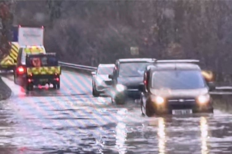 Motorists trying to work their way through flooding on the A38 in the Glynn Valley