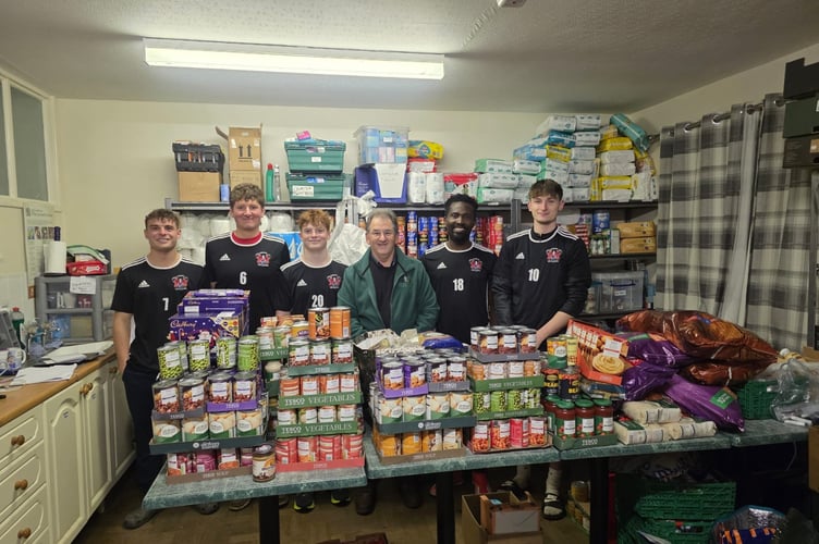 Callington Town players present some of the masses of food and supplies they have donated to Callington FoodBank. (Left to right): Fin Skews, Ben Alford, Fin Skews, Dave Whitting (Callington FoodBank), Prosper Lumor, James Brenton