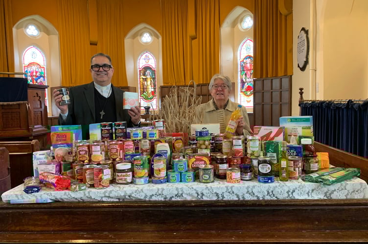Rev Oseias Da Silva and Angela Noakes with the harvest table in South Petherwin Methodist Church
