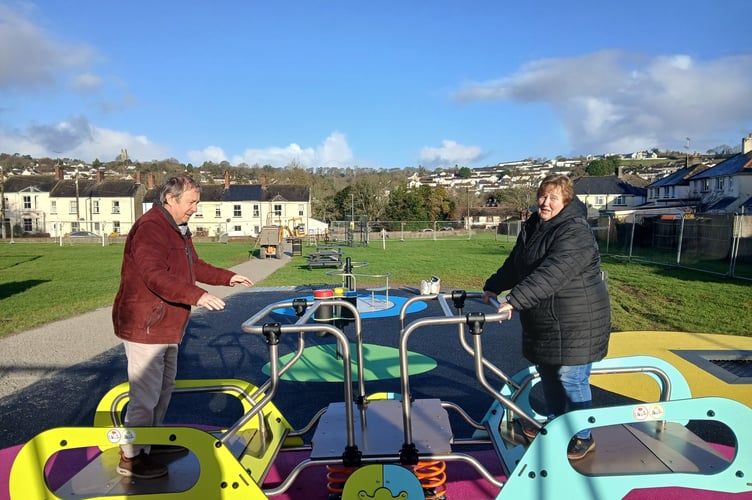 Cllr Dave Gordon and mayor Cllr Nicola Gilbert have fun testing out the new play equipment recently installed at Priory Park