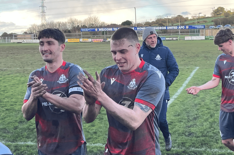 Josh McCabe and Sam Gerken applaud the Liskeard supporters.