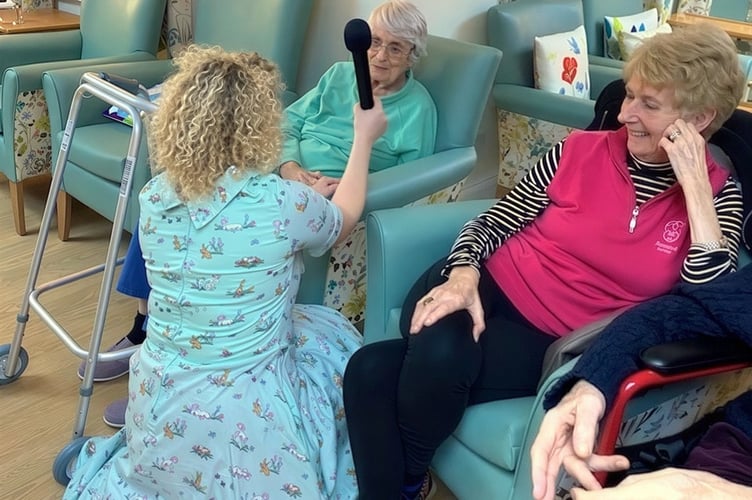 Emma Louise Richards entertaining residents at Deer Park Nursing Home (Picture: Camelot Care)