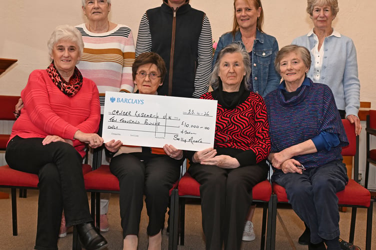 Members of the Camelford Cancer Research Committee proudly show off their cheque for the grand sum of Â£10,000 to be forwarded on to Cancer Research UK