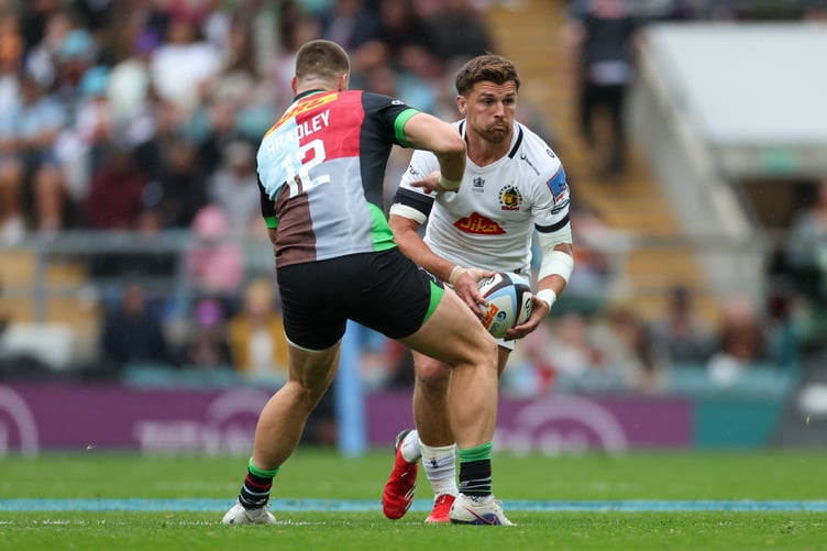 Henry Slade of Exeter Chiefs runs while under pressure from Bryn Bradley of Harlequins