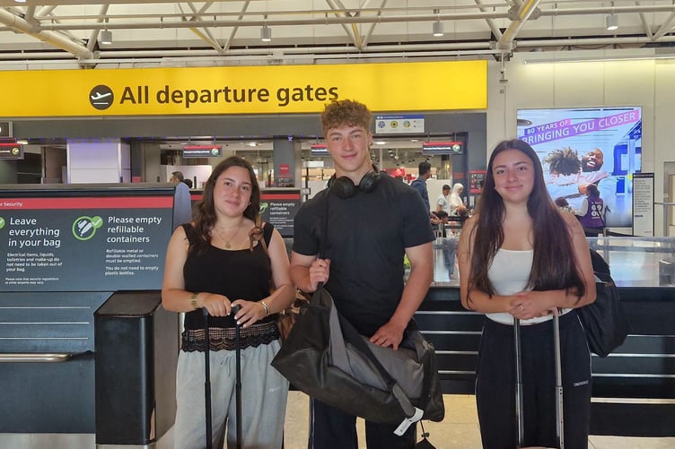 Sophia, Freddie and Natasha at the airport at the start of their trip (Picture: Shebbear College)