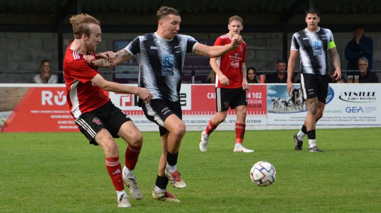 Holsworthy midfielder Jay Thomas (right) battles for position with Connor Pritchard.
